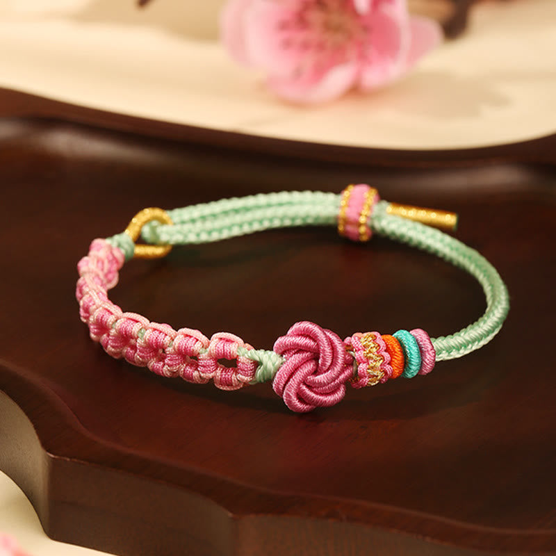 ATELIER-TIBET – Bracelet Fil Rouge Fleur de Pêcher Tressé (Nœud Symbolique)