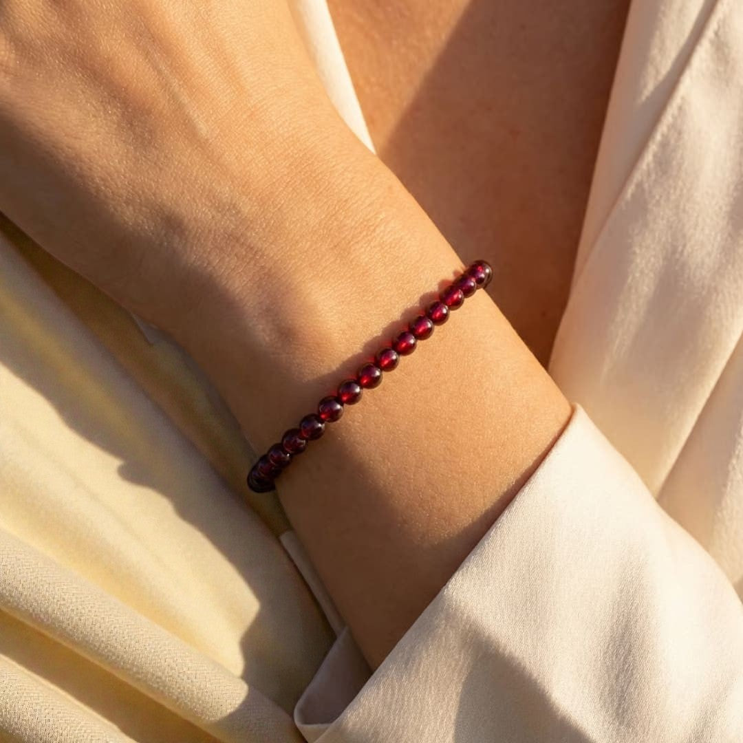 Atelier Tibet fine bracelet with 4mm deep red garnet beads on an elastic cord.