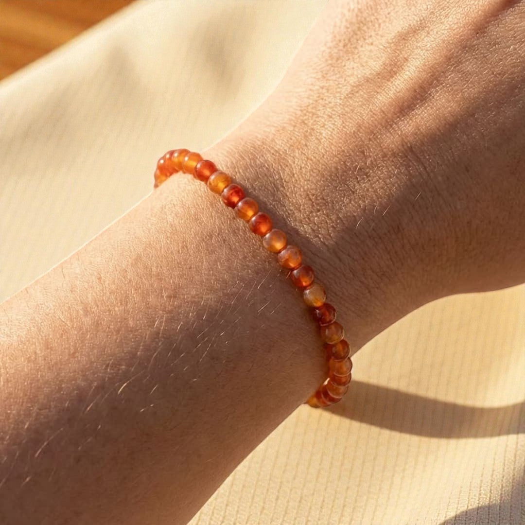 Atelier Tibet delicate bracelet with 4mm carnelian beads on a wrist, known for vitality and anchoring.
