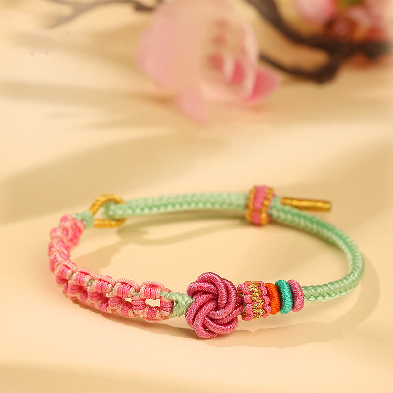 ATELIER-TIBET – Bracelet Fil Rouge Fleur de Pêcher Tressé (Nœud Symbolique)