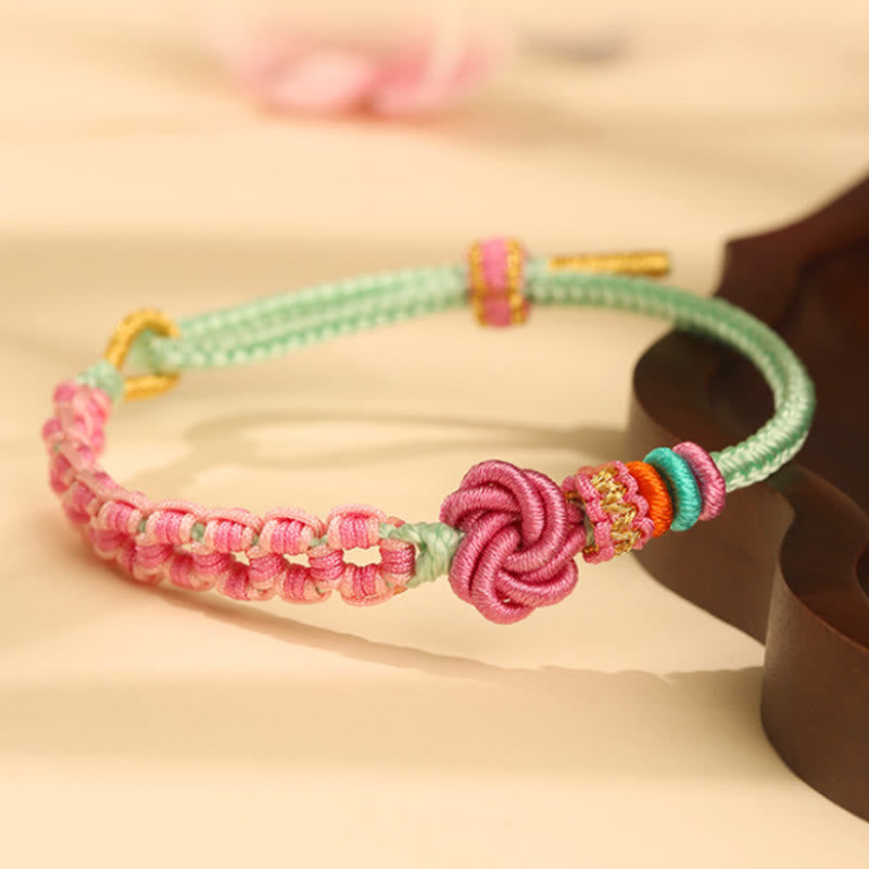 ATELIER-TIBET – Bracelet Fil Rouge Fleur de Pêcher Tressé (Nœud Symbolique)