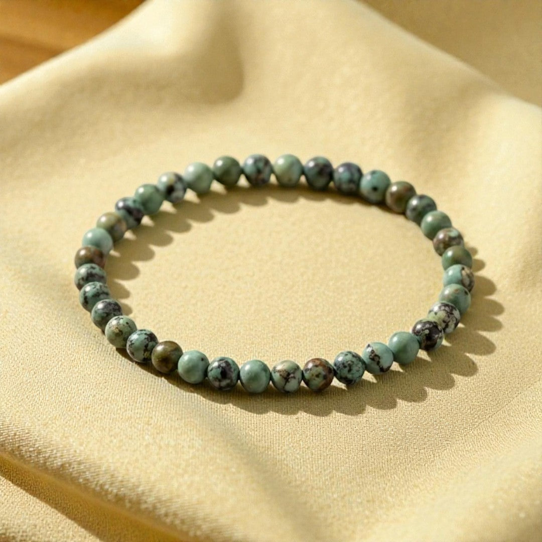Atelier Tibet fine bracelet with 4mm natural African Turquoise beads on elastic cord.