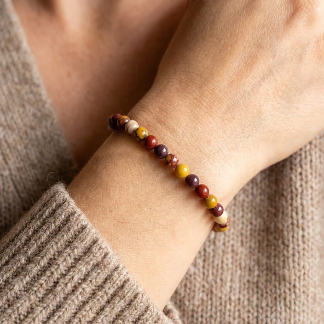 Atelier Tibet natural stone bracelet with 4mm beads in red, yellow, purple, and cream.