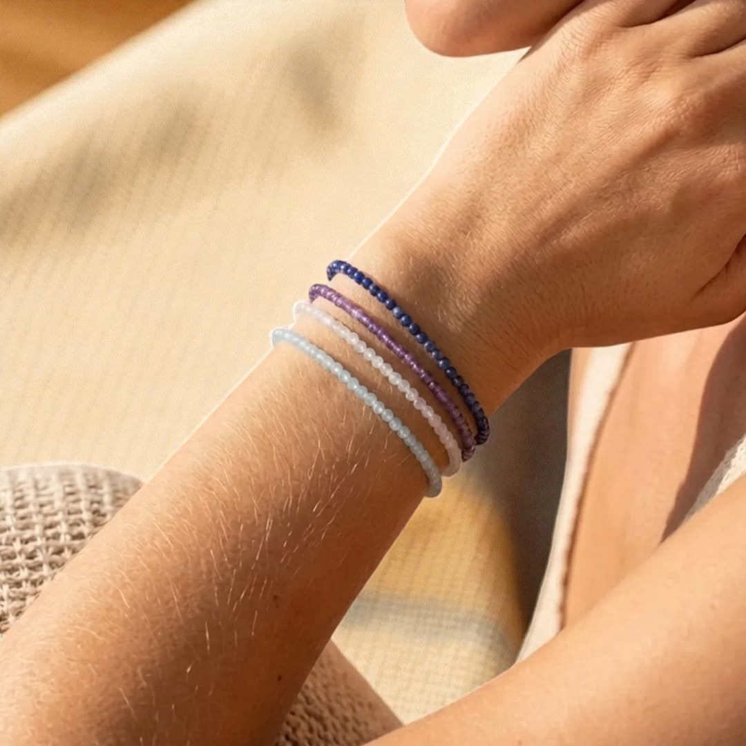 Atelier Tibet stackable bracelets with 4mm natural stones in blue, purple, and white hues.